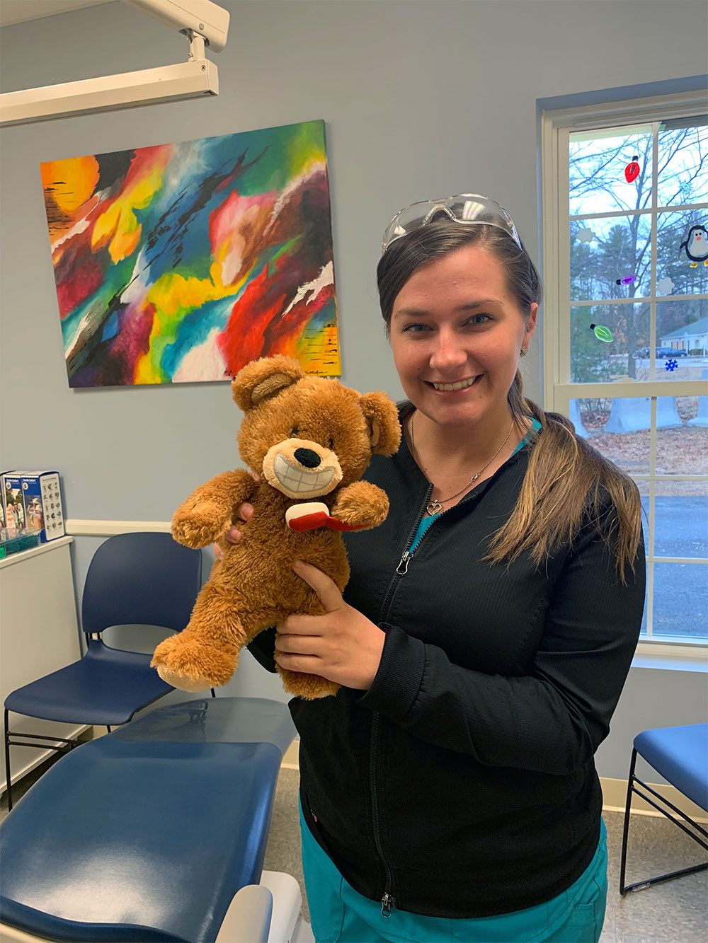 Dental Hygienist, Rachel poses with her favorite stuffed animal.