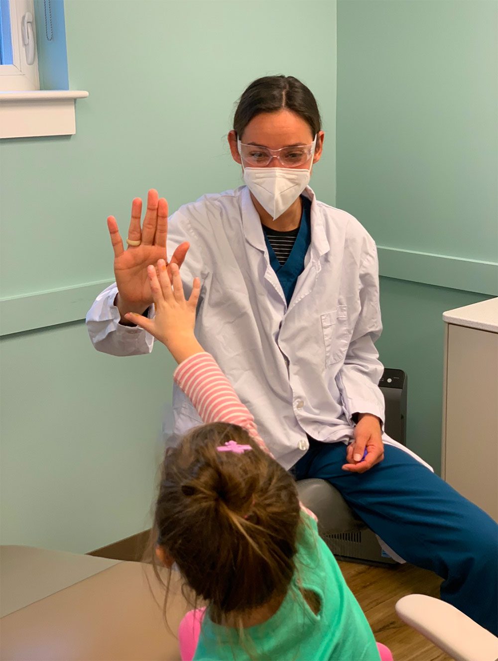 Dr. Chelsea Johnston high fives a patient at Just for Kids Pediatric Dentistry