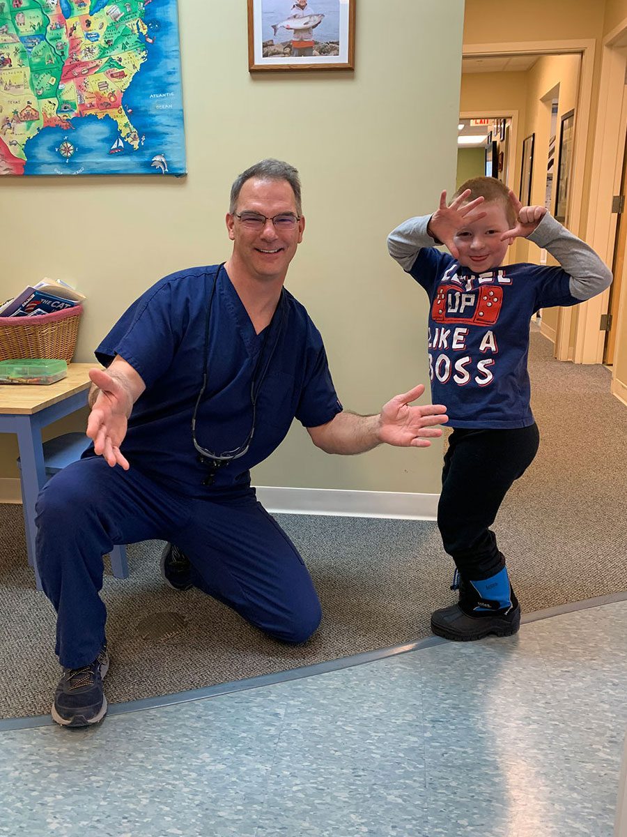 A candid photo of Dr. Michael McCoy, Pediatric Dentist at Just For Kids Pediatric Dentistry with a patient