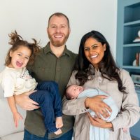 A pediatric dentist smiles with her husband and two young children in the office.