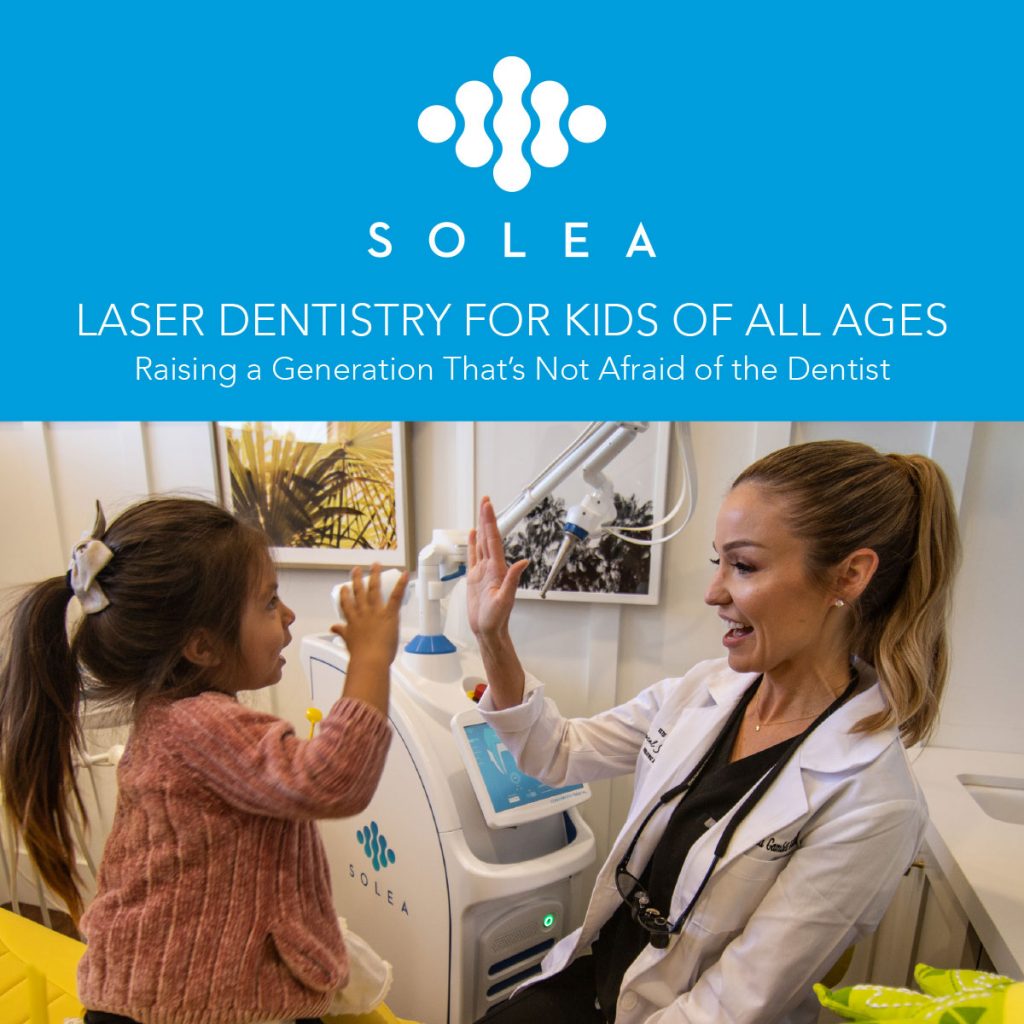 A pediatric dentist high fives her small patient, both with big smiles